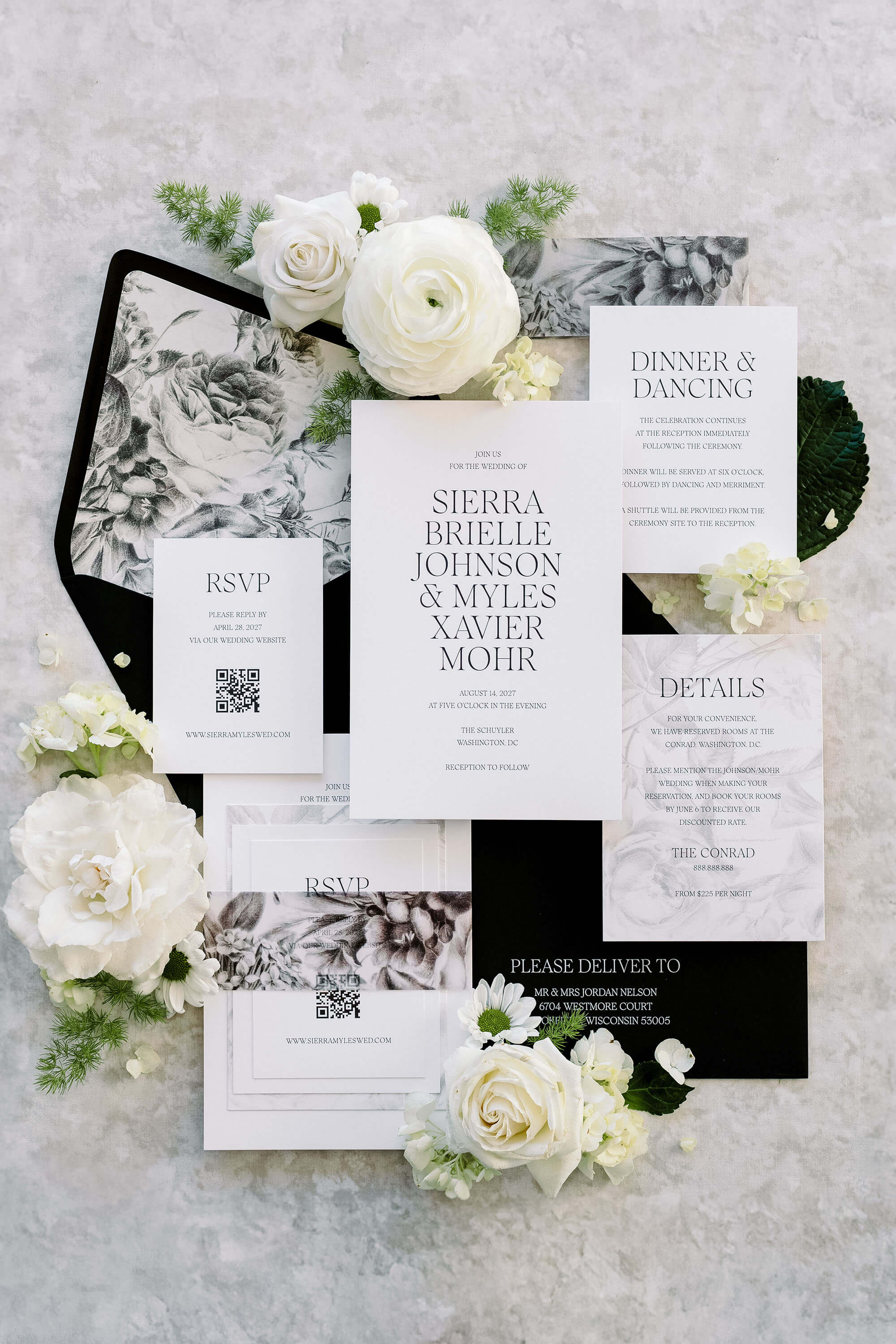 Black and white Wedding invitation set with flowers on a textured surface