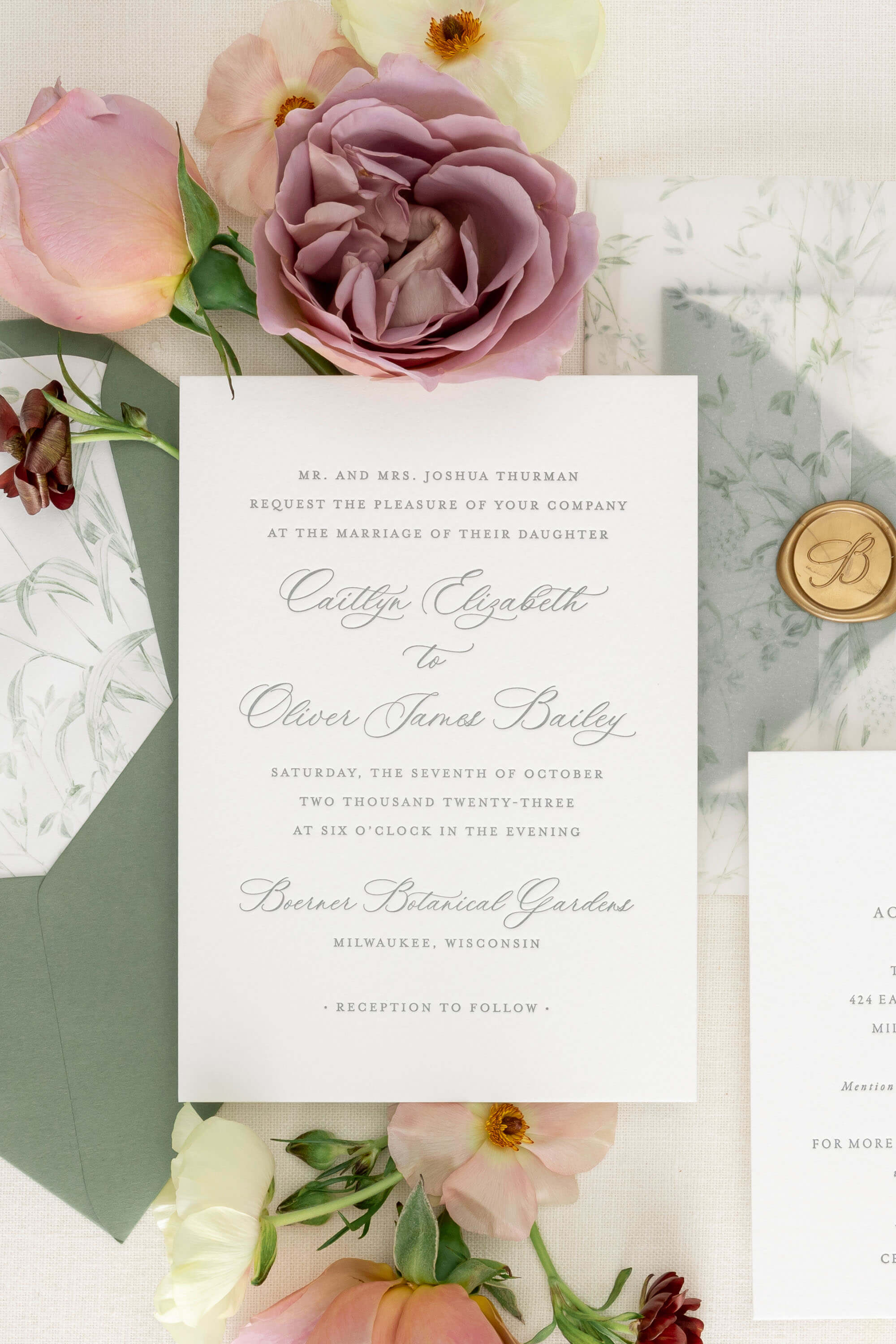 letterpress Wedding invitation card with floral decorations and a wax seal.