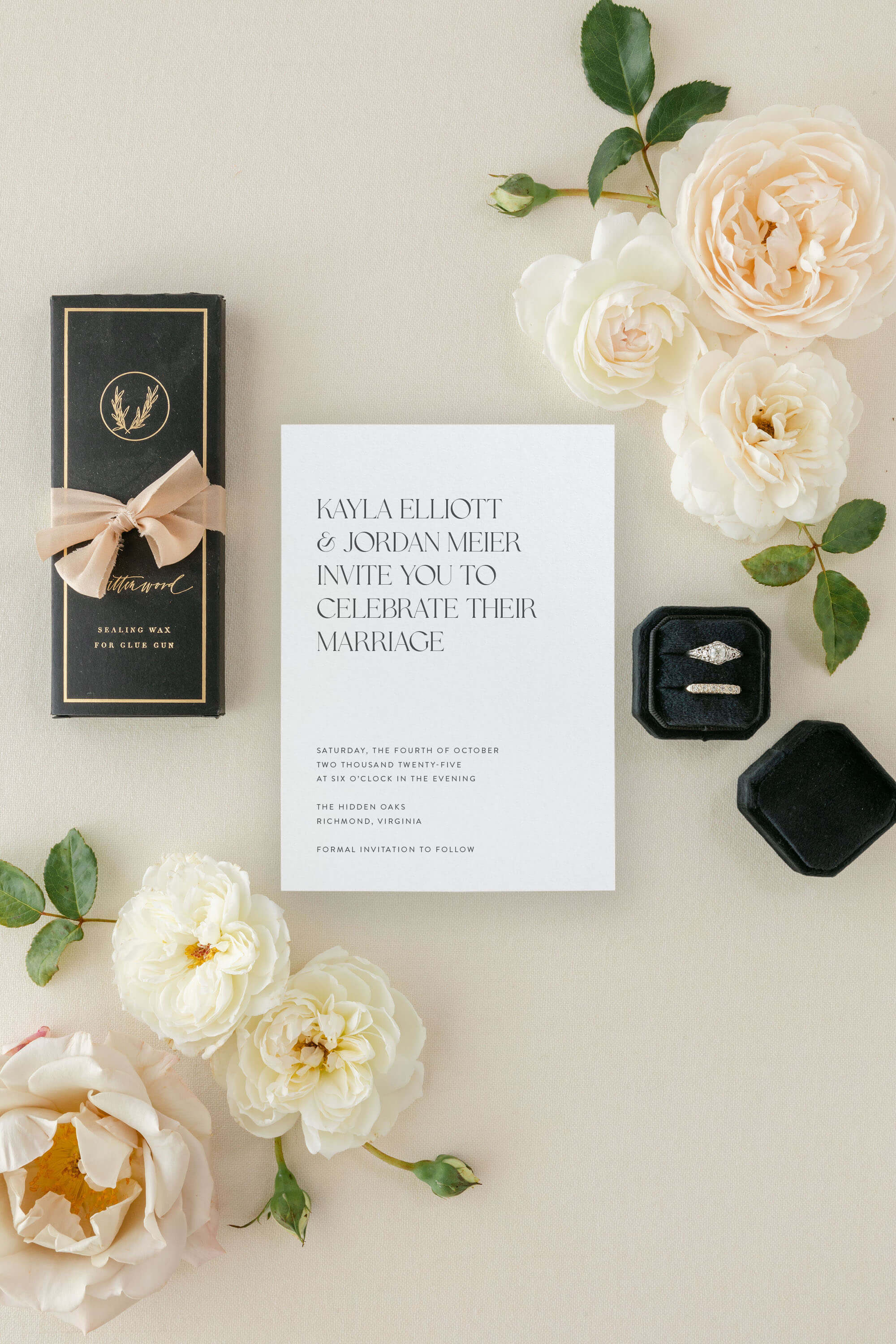Modern Wedding invitation card with flowers and rings on a light surface