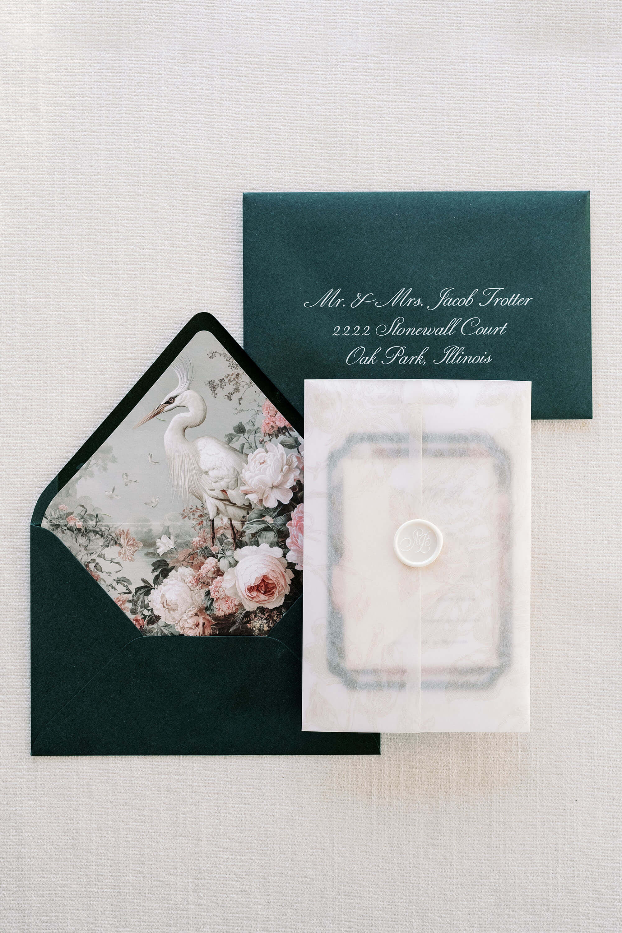 Wedding invitation set with floral envelope liner on a light gray background