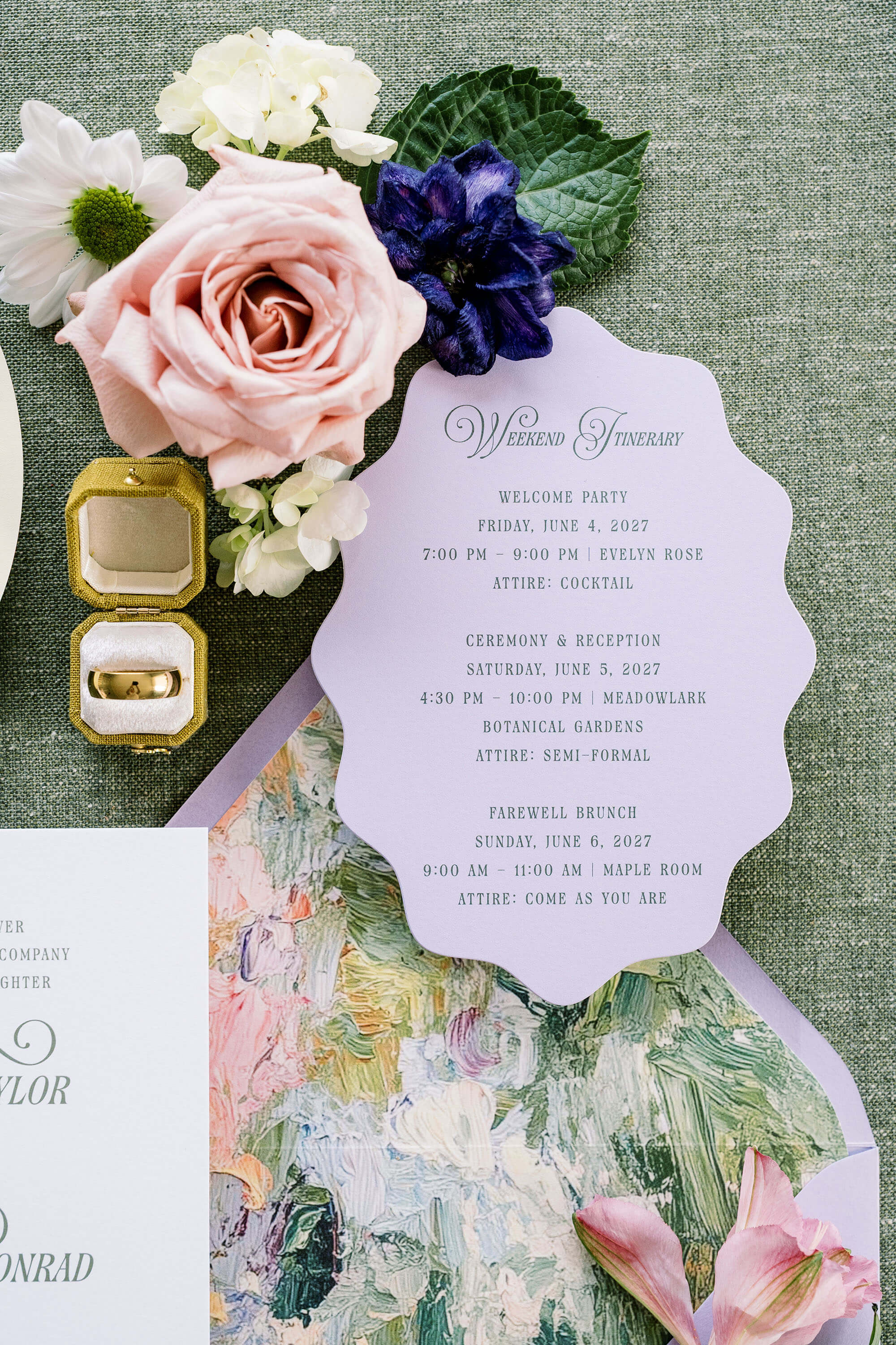 Scalloped Invitation card with floral design and jewelry on a textured surface